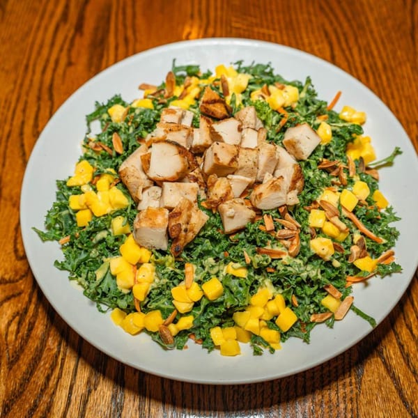 La Taguara Bar & Grill's Venezuelan kale salad with grilled chicken, mango, and almonds.